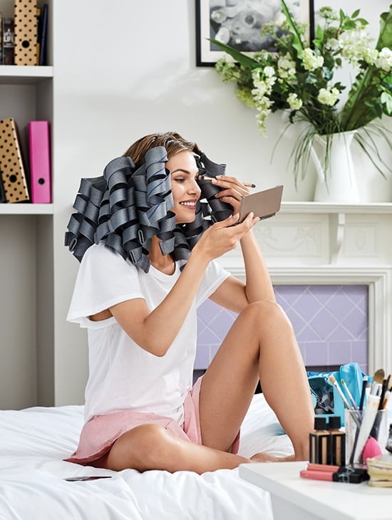 Sitting on the bed putting make up on with Waveformers in hair